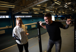 Female and male student conducting strength tests within the Human Performance Lab