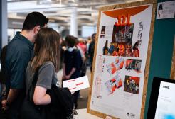 A couple look at a display of artwork