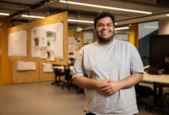 Student smiling inside the University of Salford's Architecture studios