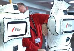 Two dresses with ipads placed within them reading Salford Business School