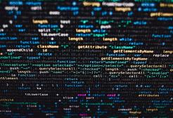 Screen close up displaying computer code with coloured syntax