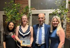 Four smartly dressed figures accept ASPHER Award 