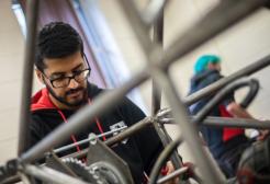 Engineering student creating a structure out of metal