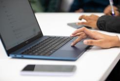 Computer with hand clicking buttons