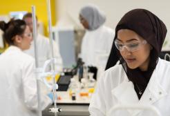 Student looking down at an experiment in a laboratory