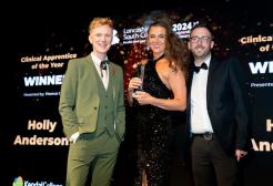 Holly Anderson receives an award from Owain Wyn Evans