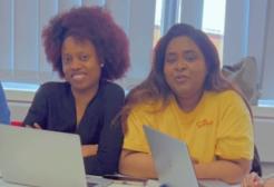 Four students sat around a table studying with their laptops