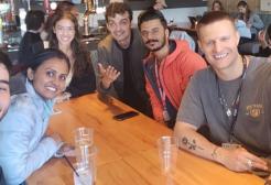 A group of students taking a selfie around a dinner table