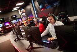 Staff using gaming workstations in the Esports Suite, Salford Business School