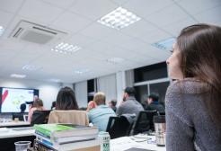 Student in class with books and laptop on table