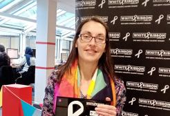 Annie holding the White Ribbon accreditation