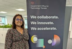Sarwat Howe stood next to a Government Office for Technology Transfer roller banner