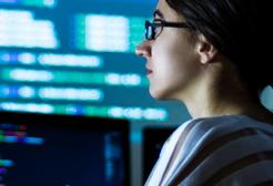 Member of staff working in front of a computer screen