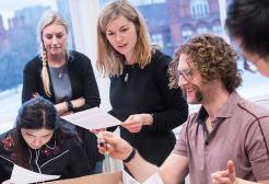 A group of MBA students from the Salford Business School work together.