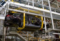 The partly-assembled chassis of a Vauxhall Astra suspended on the production line of the Vauxhall factory at Ellesmere Port Cheshire