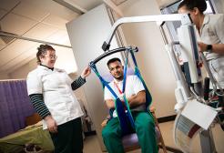 Undergraduate students using equipment while learning occupational therapy