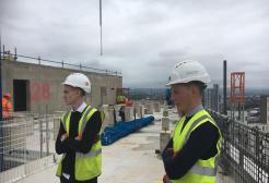 Surveying students stood on the roof of a new skyscraper in Manchester