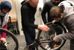 A group of people fixing a bicycle