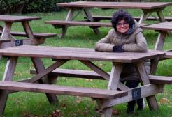 A female student sat on a park bench 