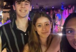 Four students taking a selfie smiling at the camera.