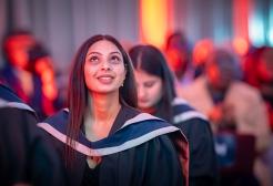 Seated graduate watching the graduation ceremony