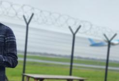 A student holding a clip board observing an airport