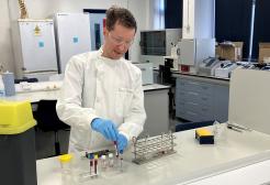 Apprentice Paul McCormick working with laboratory equipment