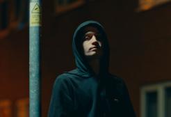 A character stands by a lamp post in the film Trapped!