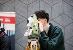Apprentice using surveying equipment as part of the Greater Manchester Construction Museum