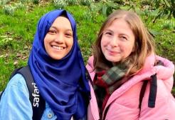 Arshiya with a fellow student in front of a hedge