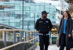 Rocio and Anthony walking down the tram platform at MediaCity