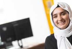 Student at the askUS help desk in University House, University of Salford
