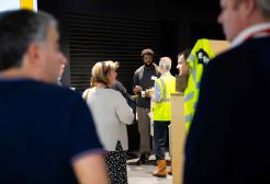 Employers networking in the SEE Building foyer, standing between Greater Manchester Construction Museum exhibits