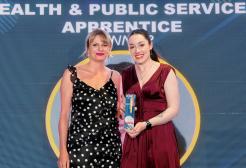 Stacey receives her award at the ceremony. She is pictured on stage holding the trophy, alongside Aimee France from Sheffield Hallam University, who presented the award.
