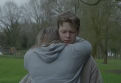 A man and woman hug in a park