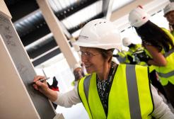 GMIoT Director Claire Foreman signs steel at new building