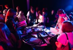 Guests inspect work at the fashion image making and styling exhbit