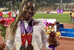 Success stands on the running track with two medals