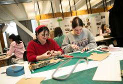 Two interior design students cutting out cardboard for their projects