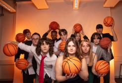 Students pose for the camera with basketballs in a promotion shoot