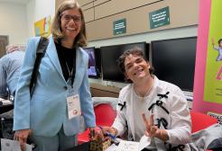 Professor Penny Cook picks up her signed copy of Rossi Griffin’s book