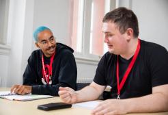 Two male Biomedical Scientist apprentices talking in a classroom