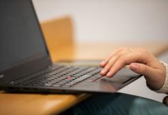 Hand typing on a laptop keyboard