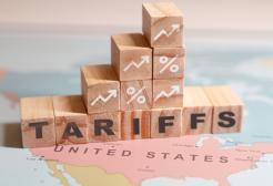 Building blocks with graph and tariff lettering on top of a map of the USA