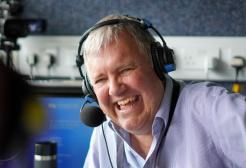 Clive Tyldesley doing commentary in a gantry
