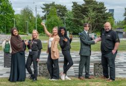 A group of six people pose on the University's Peel Park campus