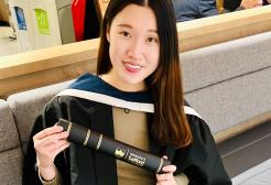 Wing at graduation holder her scroll