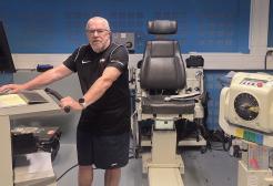 A sport and exercise science student using equipment for his research n the physiology room