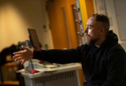 Mike speaking with his arm extended 