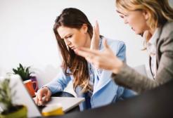 Two angry colleagues next to each other. Credit to iStock, powered by Getty Images.